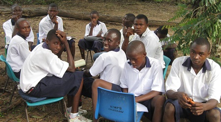 Before the school was finished (Spring 2012), many of our classes were setup outside like this.  Despite these conditions, this group of boys was the first group to ever pass the national exams from our school!